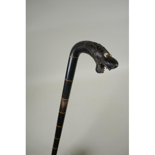 291 - An antique Chinese carved horn walking stick with dragon head handle, 86cm