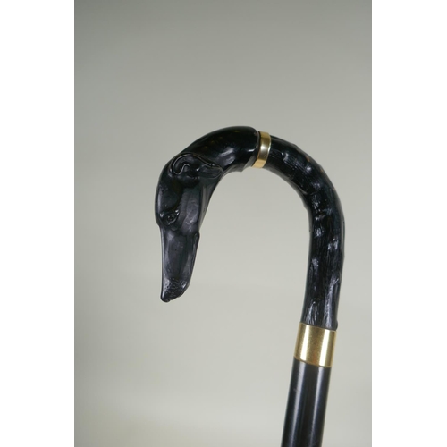 292 - A blackthorn walking stick with a hallmarked silver cuff, and another walking stick with cast compos... 