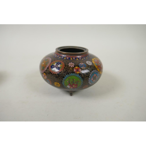 294 - A pair of Japanese Meiji cloisonne pots on tripod supports decorated with floral panels and mons, a ... 