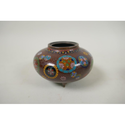 294 - A pair of Japanese Meiji cloisonne pots on tripod supports decorated with floral panels and mons, a ... 