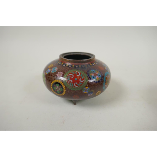 294 - A pair of Japanese Meiji cloisonne pots on tripod supports decorated with floral panels and mons, a ... 