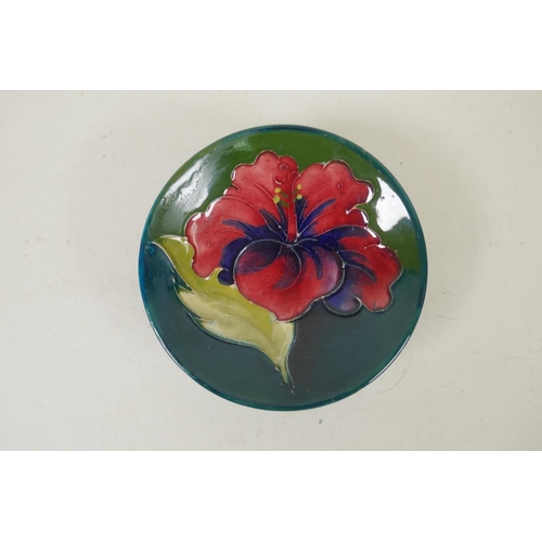 296 - Three Moorcroft pin dishes decorated with hibiscus, pink magnolia, and berry and leaf, and a hibiscu... 