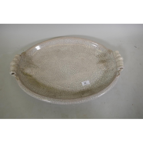 31 - A large crackle glazed ceramic serving dish, marked PTMD, 57cm long