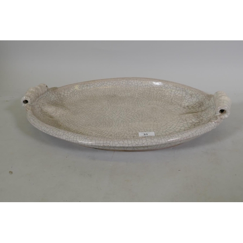 31 - A large crackle glazed ceramic serving dish, marked PTMD, 57cm long