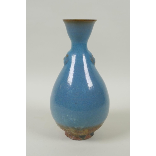 38 - A Chinese Jun ware pottery vase, with twin mask decoration, 20cm high