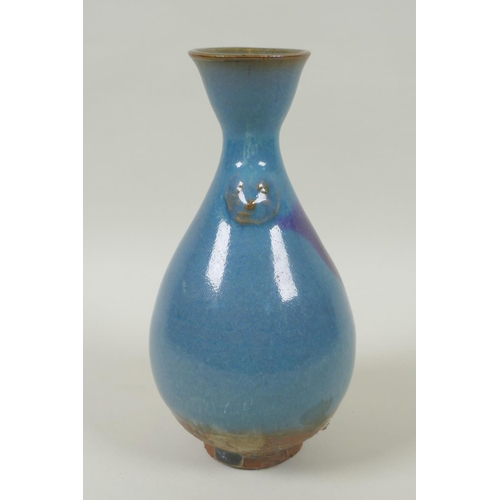 38 - A Chinese Jun ware pottery vase, with twin mask decoration, 20cm high