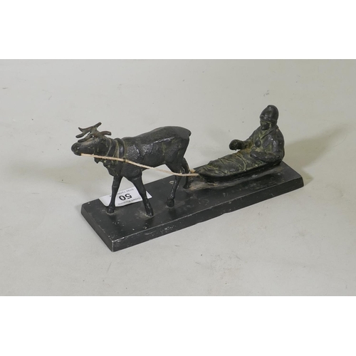 50 - An antique bronzed metal figure of a moose pulling a man in a sled, signed J. Benell-Eneret, 18cm lo... 