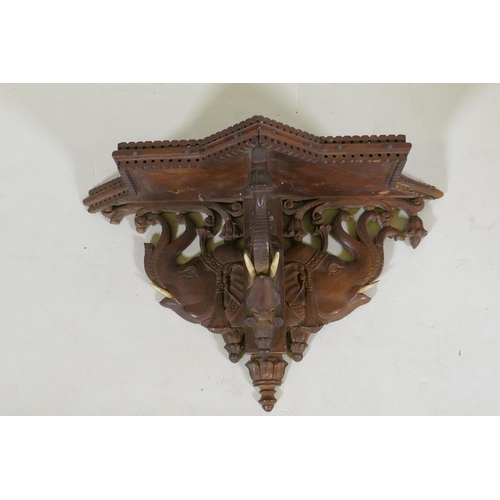 52 - A C19th Anglo-Indian carved wall bracket in the form of three elephant heads, 34cm wide, 21cm high