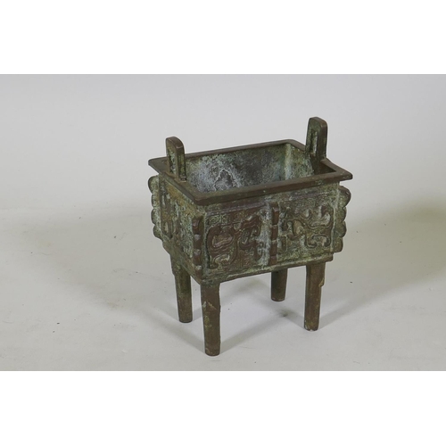 56 - Chinese bronze two handled censer with raised archaic style decoration, 12 x 9 x 15cm