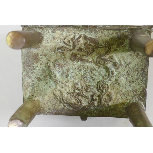 56 - Chinese bronze two handled censer with raised archaic style decoration, 12 x 9 x 15cm