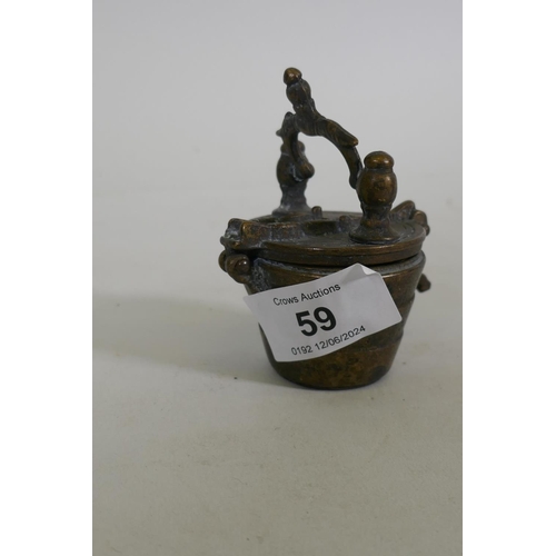 59 - A set of oriental bronze graduated weights in a case, 8cm high