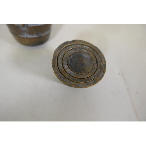 59 - A set of oriental bronze graduated weights in a case, 8cm high