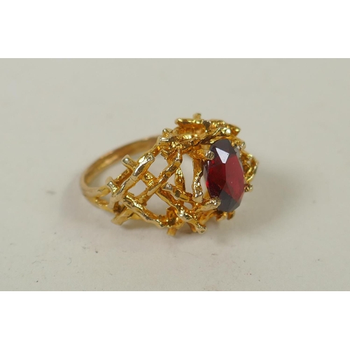 604 - A yellow metal garnet set twig ring, tests as gold, marks rubbed, probably 14ct, 6.4g gross, size M