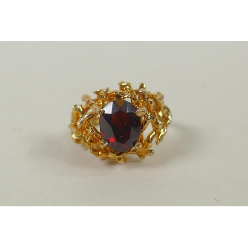 604 - A yellow metal garnet set twig ring, tests as gold, marks rubbed, probably 14ct, 6.4g gross, size M