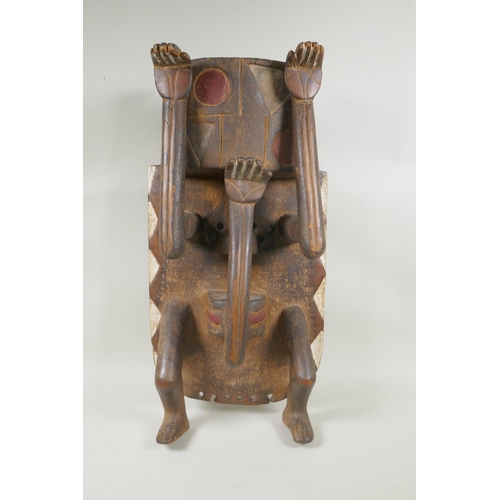 67 - An antique African carved wood figural mask with painted details, 29 x 58cm