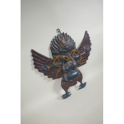 68 - A Tibetan cold painted pressed metal Garuda wall mount, 45 x 47cm