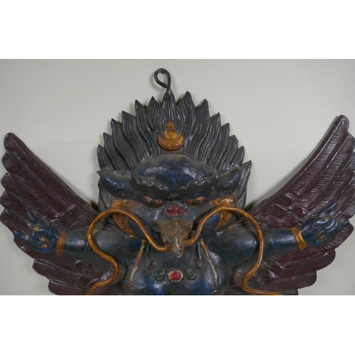 68 - A Tibetan cold painted pressed metal Garuda wall mount, 45 x 47cm