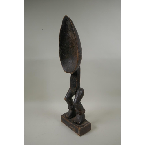 69 - An African Ivory Coast carved wood Dan peoples ceremonial Wakemia ladle, 57cm high