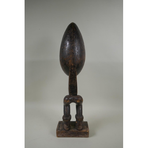 69 - An African Ivory Coast carved wood Dan peoples ceremonial Wakemia ladle, 57cm high