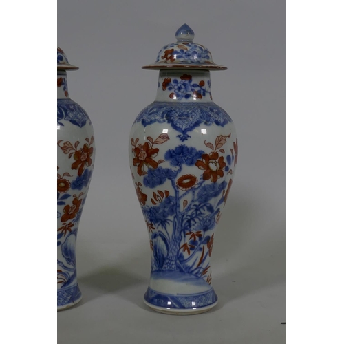 7 - A Pair of C19th Chinese Imari pattern vases with covers, AF chips, racks and repairs, 28cm high