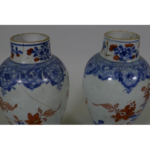 7 - A Pair of C19th Chinese Imari pattern vases with covers, AF chips, racks and repairs, 28cm high