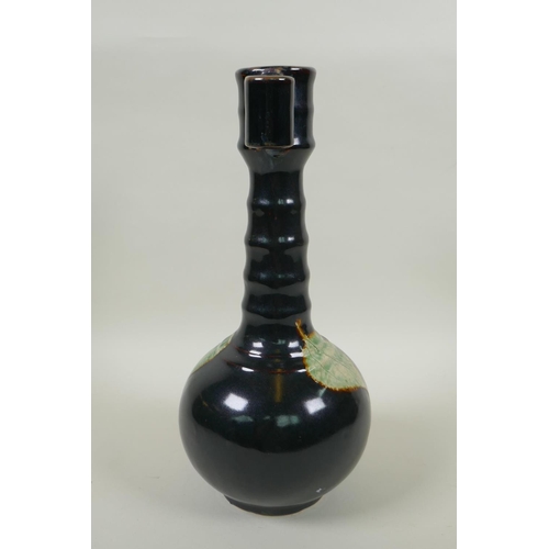 75 - A Chinese Jian ware bottle vase with ribbed neck, two lug handles and decorated with a leaf skeleton... 