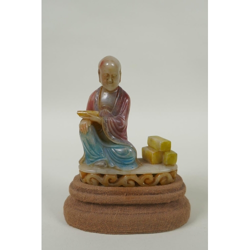 78 - A Chinese carved and dyed soapstone figure of Lohan, on a display stand, AF repair, 13cm high