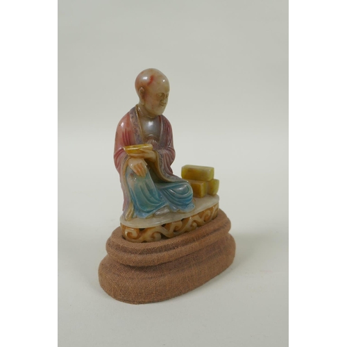 78 - A Chinese carved and dyed soapstone figure of Lohan, on a display stand, AF repair, 13cm high