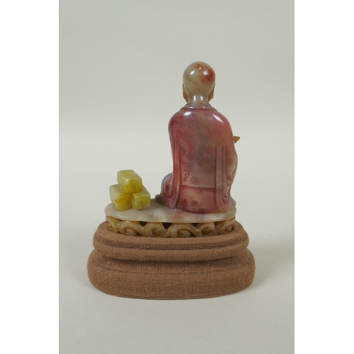 78 - A Chinese carved and dyed soapstone figure of Lohan, on a display stand, AF repair, 13cm high