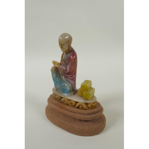 78 - A Chinese carved and dyed soapstone figure of Lohan, on a display stand, AF repair, 13cm high