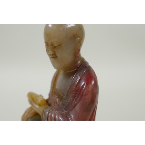 78 - A Chinese carved and dyed soapstone figure of Lohan, on a display stand, AF repair, 13cm high