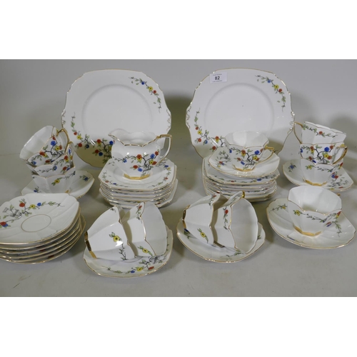 82 - A vintage Bohemian 12 place porcelain tea set with floral decoration, sandwich plate 23cm diameter, ... 