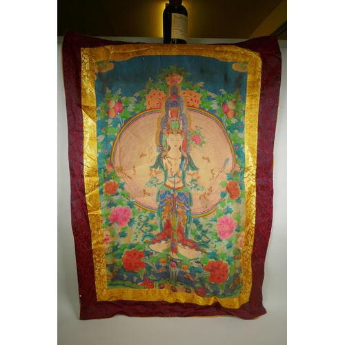 95 - A Tibetan printed thangka within a silk mount, 74 x 106cm