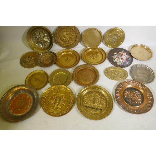 96 - A quantity of copper and brass wall plaques and trays, largest 46cm diameter