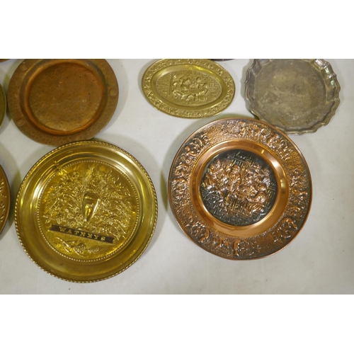 96 - A quantity of copper and brass wall plaques and trays, largest 46cm diameter