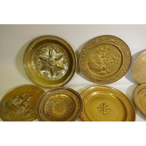 96 - A quantity of copper and brass wall plaques and trays, largest 46cm diameter