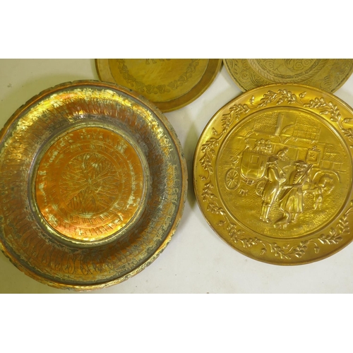 96 - A quantity of copper and brass wall plaques and trays, largest 46cm diameter