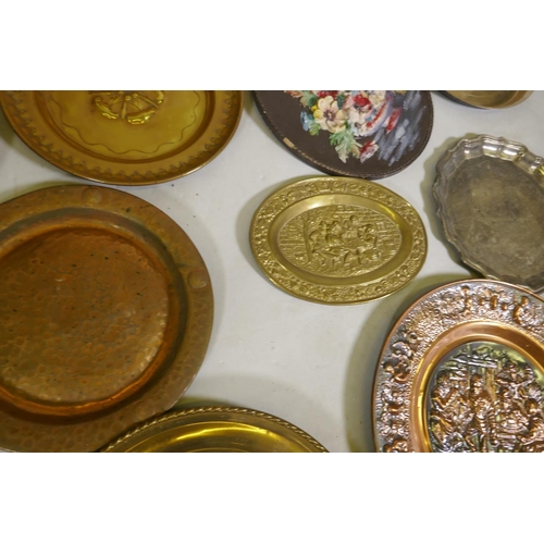 96 - A quantity of copper and brass wall plaques and trays, largest 46cm diameter