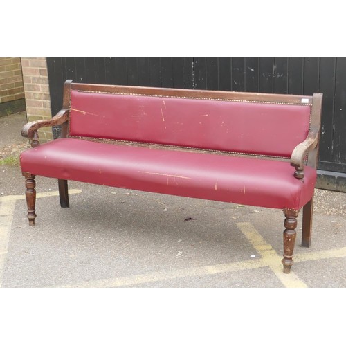 1215 - An antique beechwood bench with leatherette upholstery, 183cm long