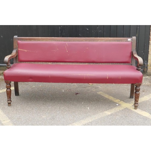 1215 - An antique beechwood bench with leatherette upholstery, 183cm long