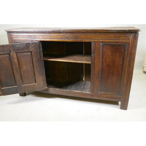 1093 - An C18th oak side cabinet with single panelled door cupboard and moulded details, 138 x 43 x 85cm, r... 