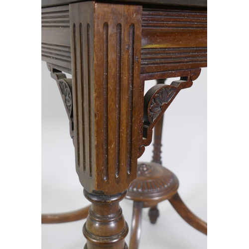 1196 - A Victorian mahogany envelope card table, raised on ring turned fluted supports with scroll ends, th... 