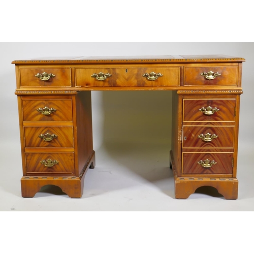 1155 - A Georgian style mahogany pedestal desk with inset leather top, six drawers and cupboard, raised on ... 