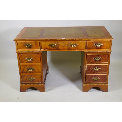 1155 - A Georgian style mahogany pedestal desk with inset leather top, six drawers and cupboard, raised on ... 