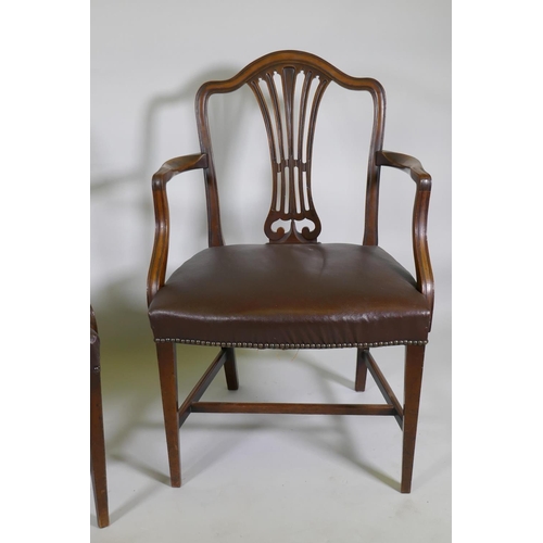 1173 - A pair of C19th Hepplewhite style elbow chairs with pierced splat backs and studded leather seats, r... 