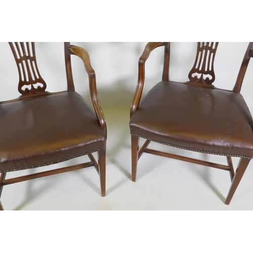 1173 - A pair of C19th Hepplewhite style elbow chairs with pierced splat backs and studded leather seats, r... 