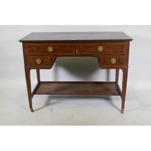 1152 - A late C19th/early C20th inlaid mahogany four drawer kneehole writing/dressing table, raised on tape... 