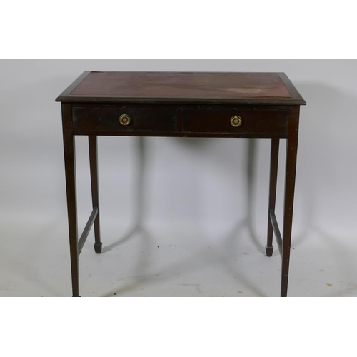 1153 - A Victorian mahogany two drawer writing table with inset faux leather top, raised on tapering suppor... 