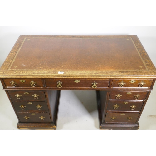 1224 - A Victorian oak on pine pedestal desk, with leather inset top, nine drawers with original brass hand... 