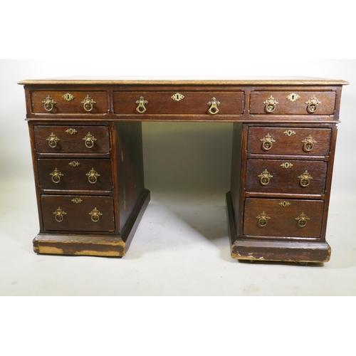 1224 - A Victorian oak on pine pedestal desk, with leather inset top, nine drawers with original brass hand... 